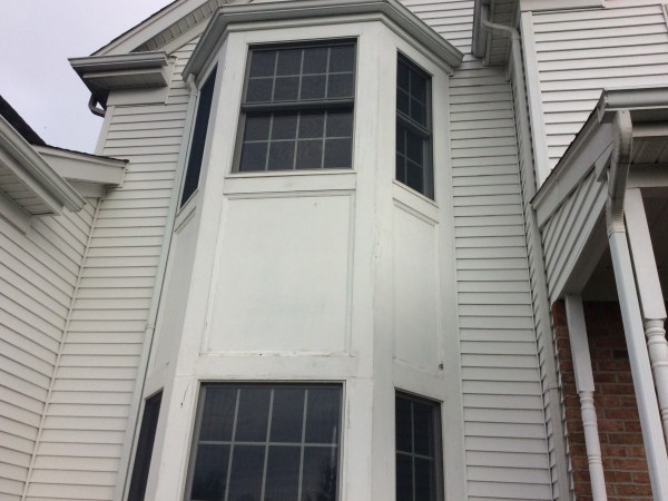 Exterior siding, trim and bay window ready for repair and repainting