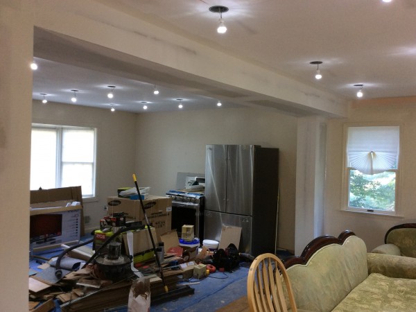 Open-concept kitchen remodel with new recessed lighting and fresh drywall