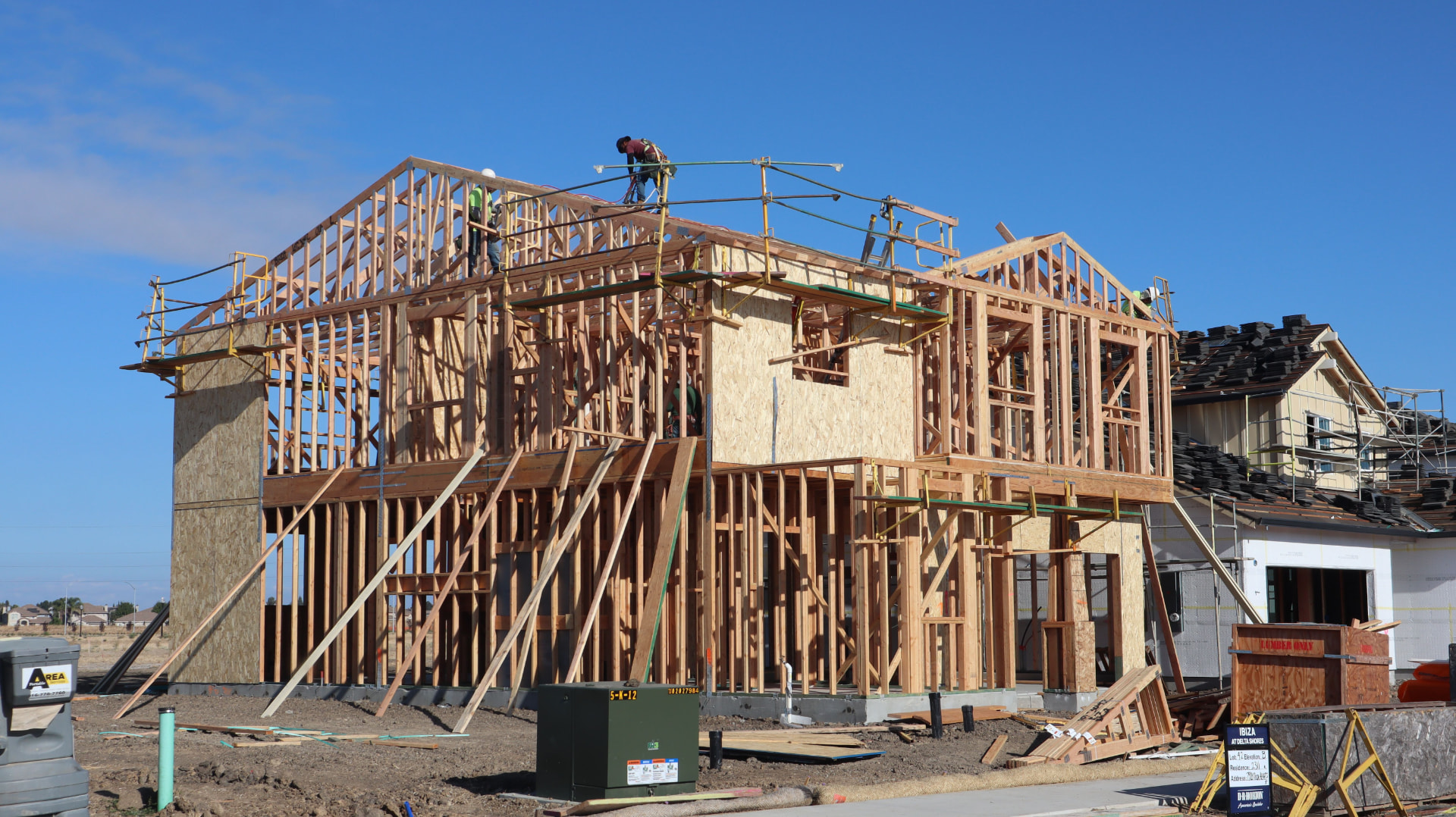 Carpenters framing a new two-story home addition